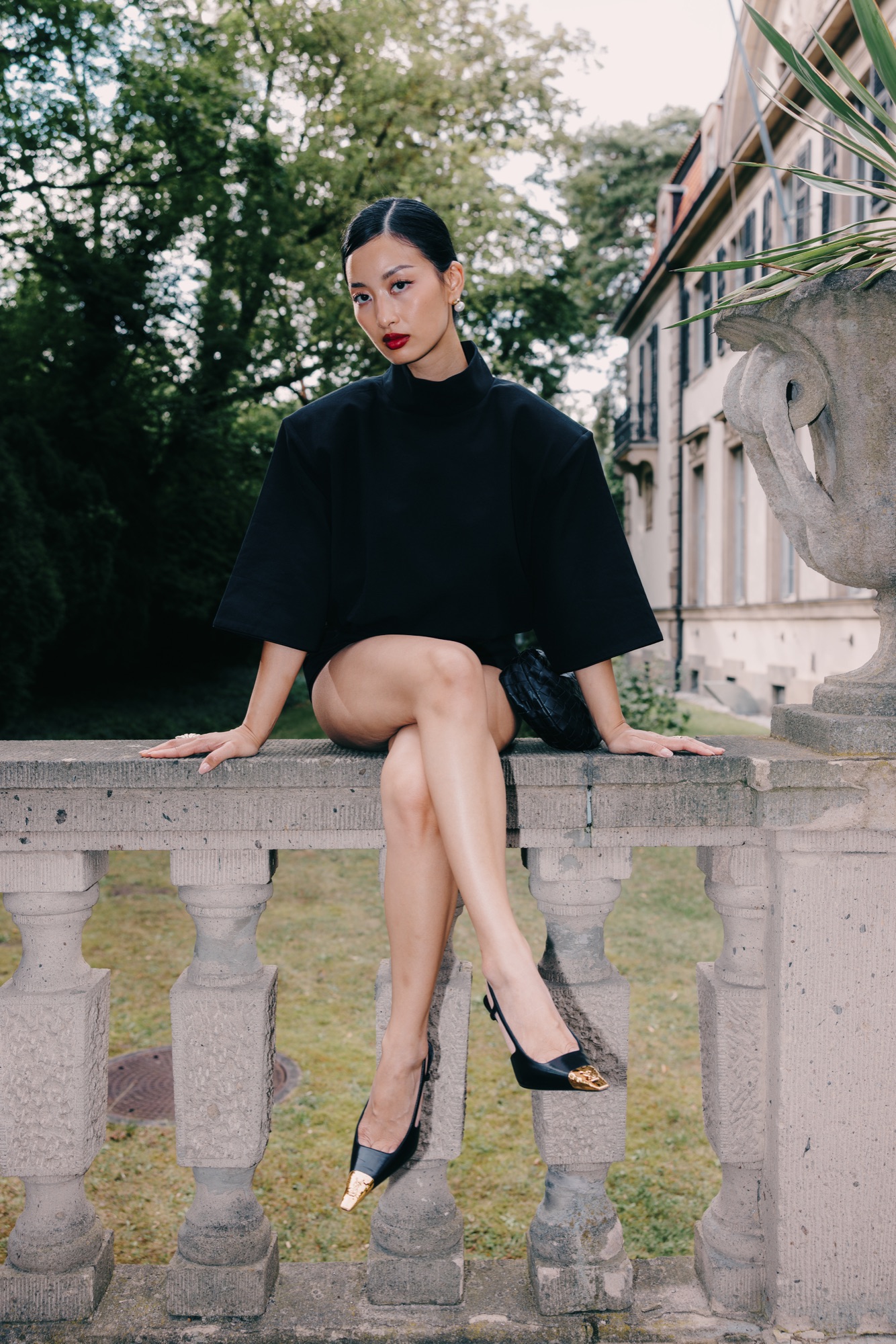 Thanya x PRADA – Elegantes Porträt an der Schlosspark-Balustrade mit Prada Tasche